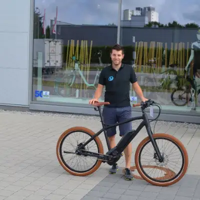 Fachhändler Markus Blust steht mit seinem Fahrrad vor seinem Radladen